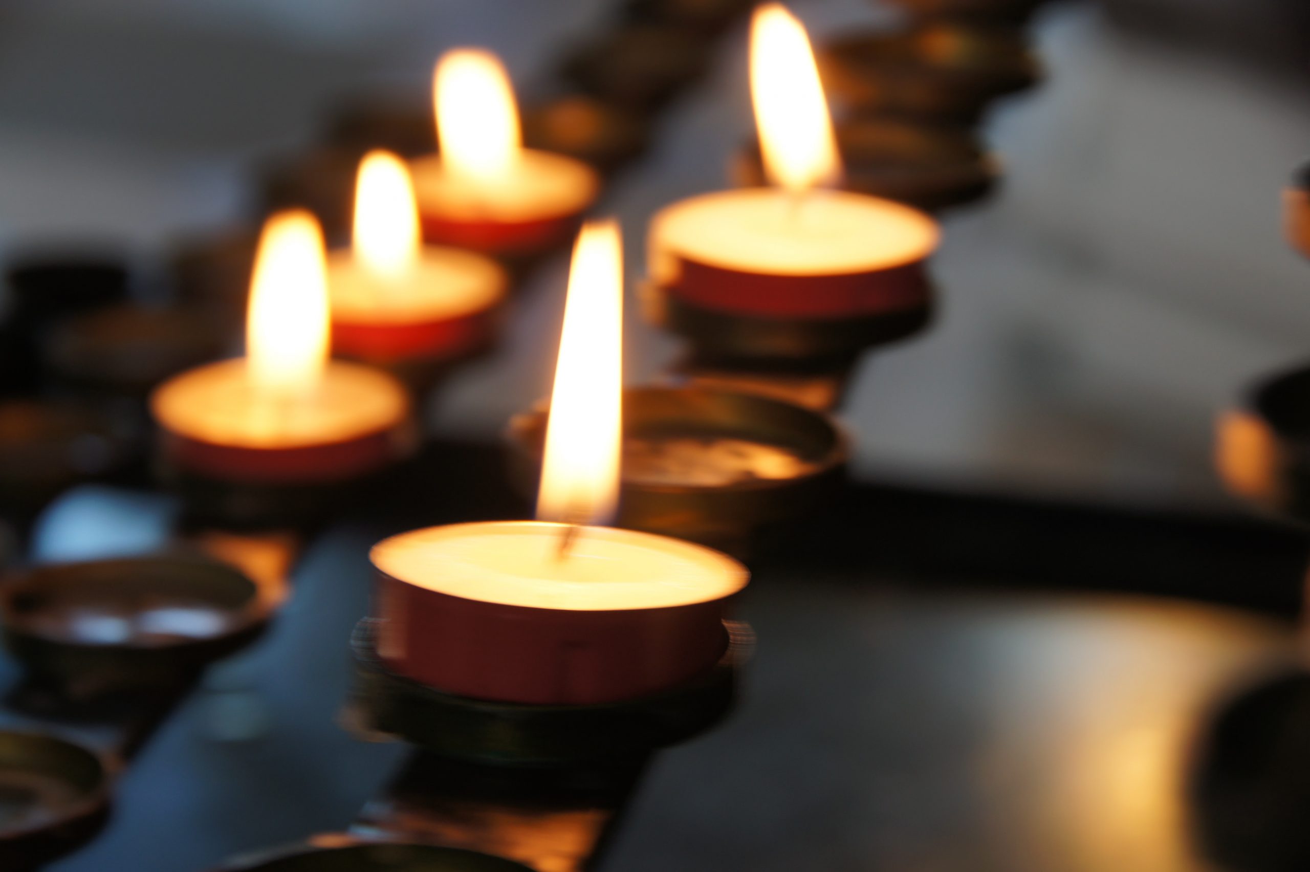 Photo of votive candles in the Funerals Life Events column